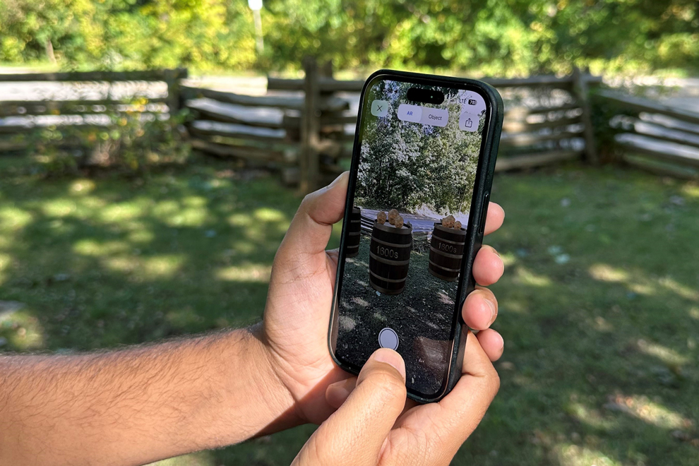 person holding cell phone with augmented reality onscreen