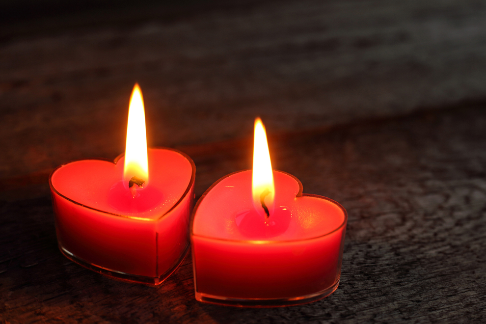 two heart-shaped candles burning