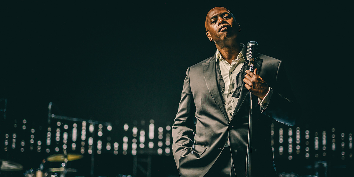 Terrell Edwards posing with a microphone.