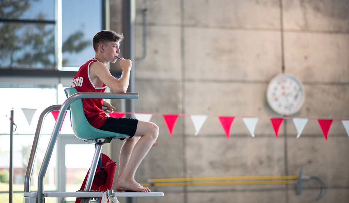 A lifeguard watching the swimming pool.