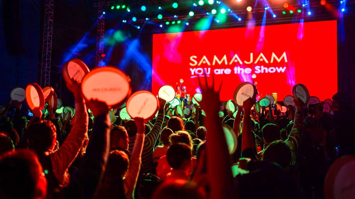 Crowd photo of people using tambourines. 