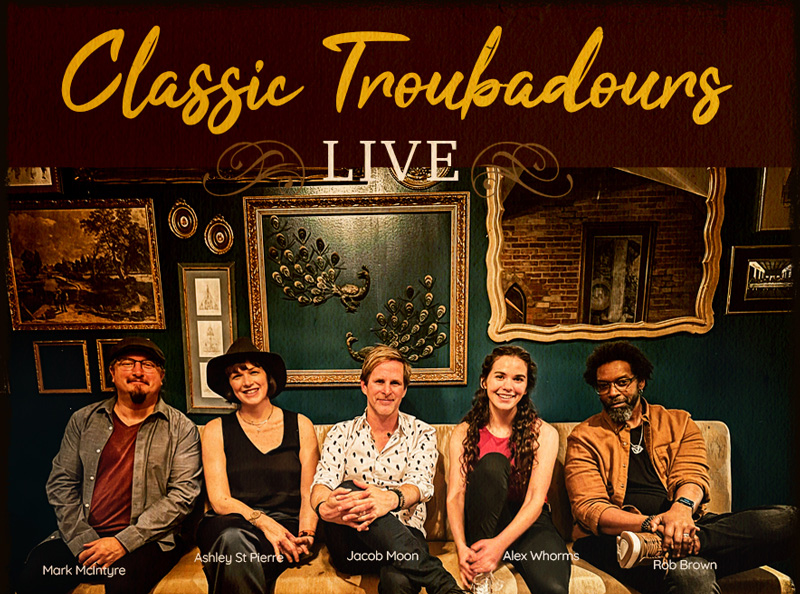 The members of Classic Troubadours Live sitting on a couch.