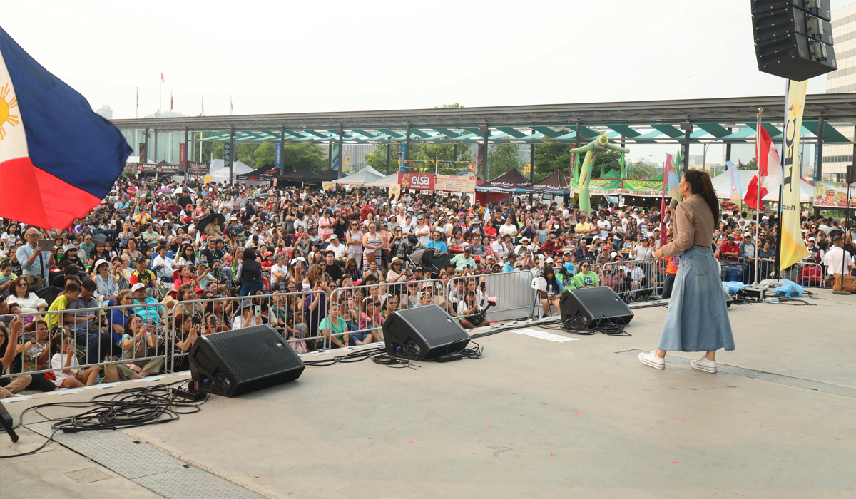 A performer on stage at Celebration Square