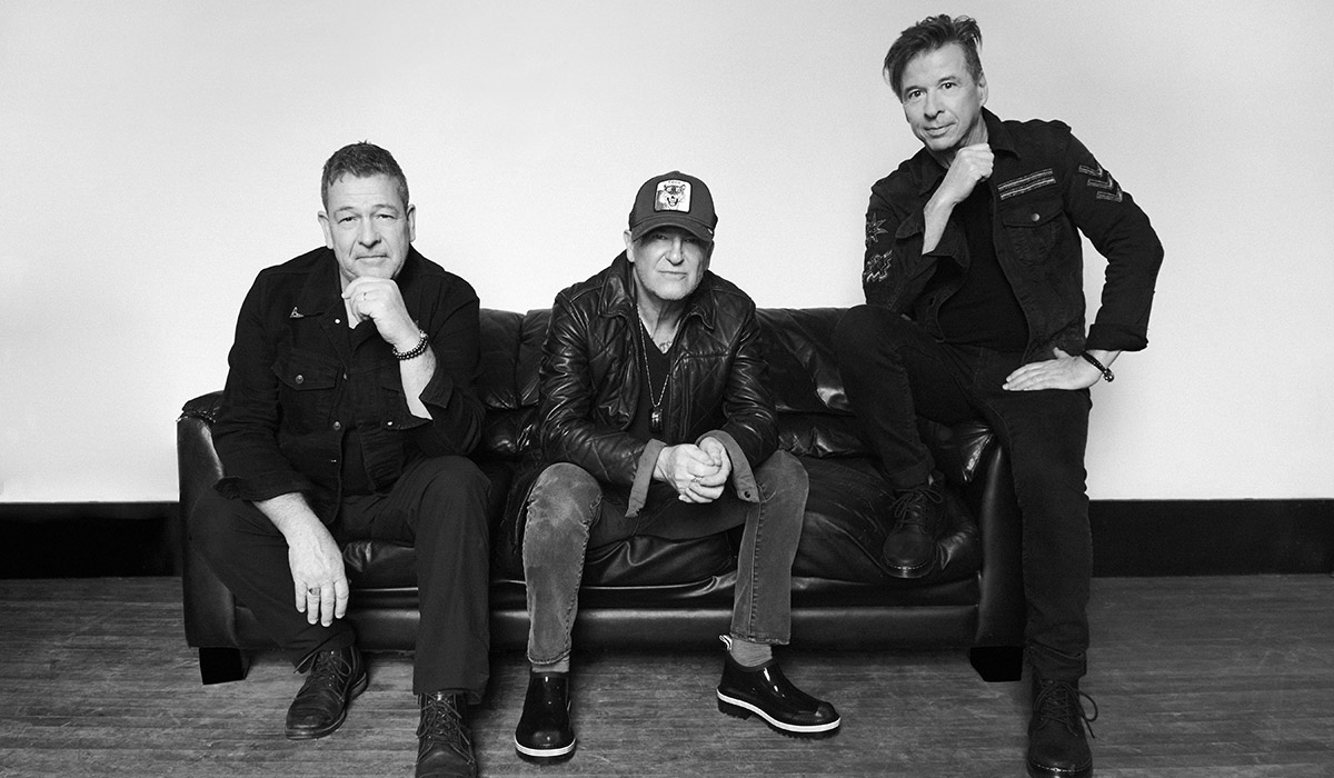 The members of Glass Tiger sitting on a couch