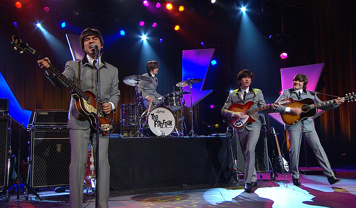 Members of the Fab Four performing on stage