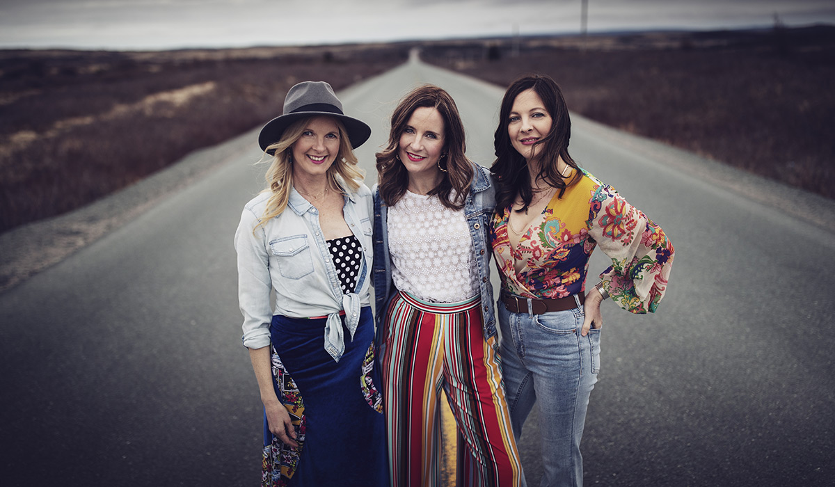 The Ennis Sisters standing on a road