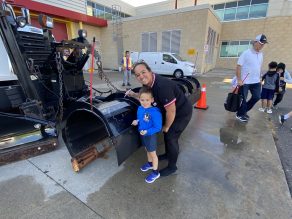 Child and parent with a snow plow