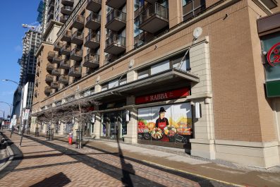 An apartment building with stores on the ground floor