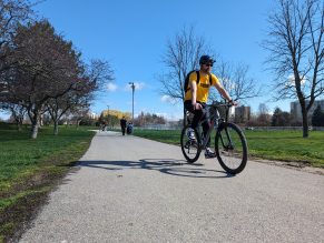 Person riding bike on park trail