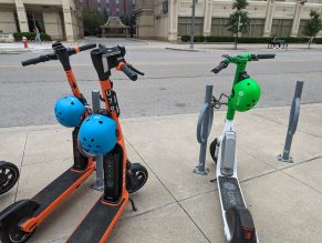 Close up of shared e-scooters locked up.