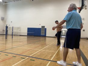 A set of older adults playing pickleball in a gym at a local Mississauga Community Center.