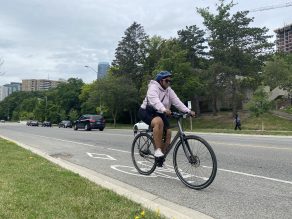 Person riding bike in cycling lane in Mississauga