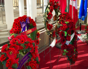 Collection of wreaths on a red carpet.