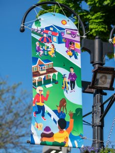 A vinyl street banner mounted a light pole.