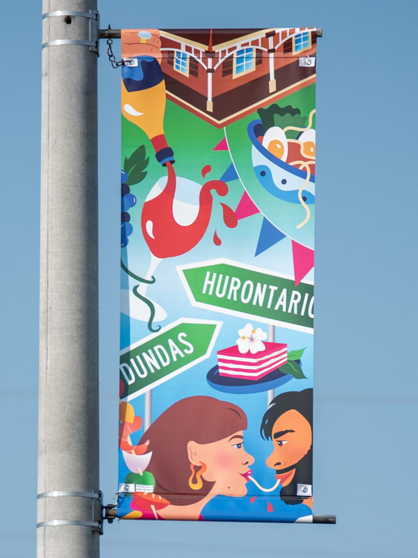 A vinyl street banner mounted a light pole.