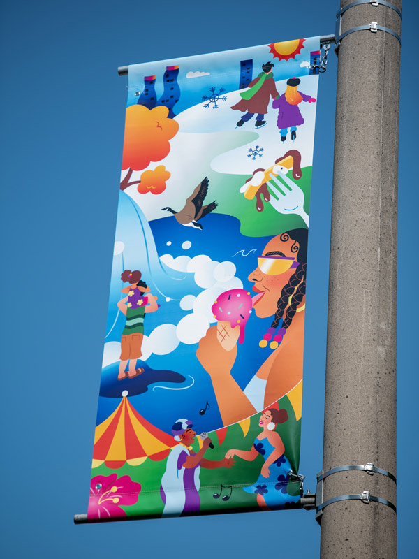 A vinyl street banner mounted a light pole.