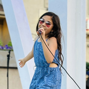 Kalia Stapleton singing outdoors.