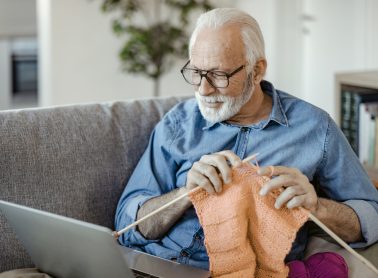 Senior Man doing Knit Work Watching Online Tutorial at Home