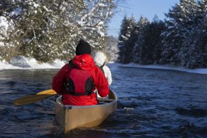 Couple canoeing in the winter on a lake