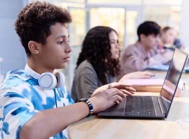 Group of students on their laptops in class