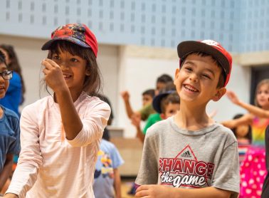 A boy and girls having fun at camp