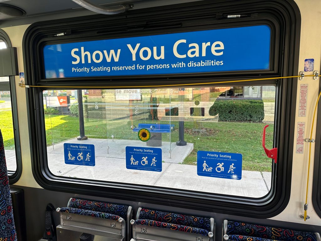 Priority seating area on the bus with the sunflower logo